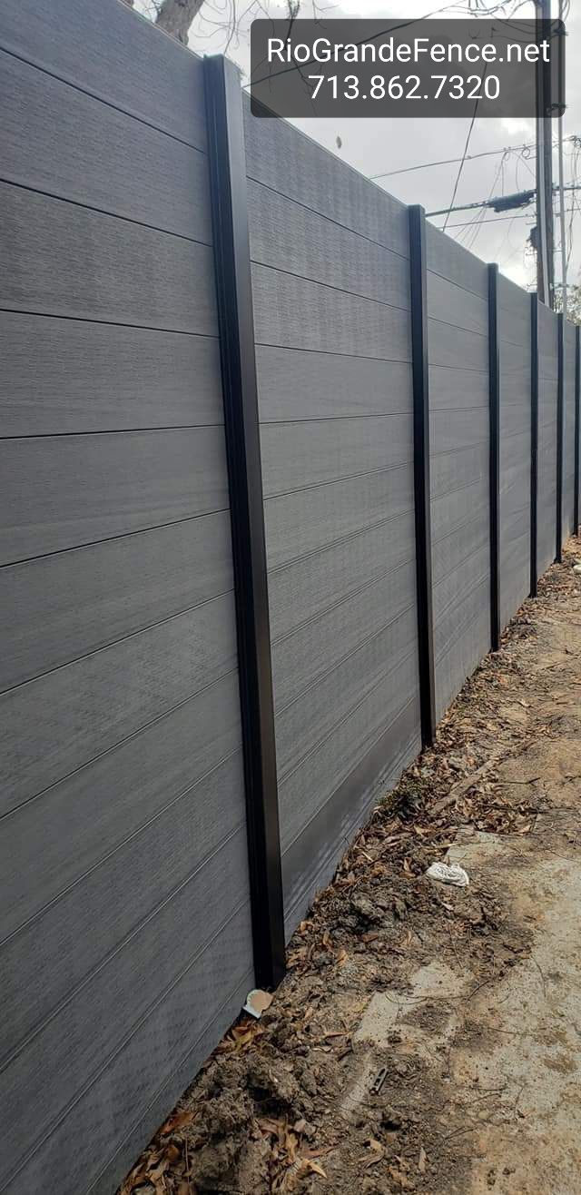 A Gray Fence Is Sitting on Top of A Dirt Field - Houston, TX - Rio Grande Fence Company
