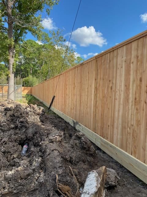 A Wooden Fence Is Being Built Next to A Pile of Dirt - Houston, TX - Rio Grande Fence Company