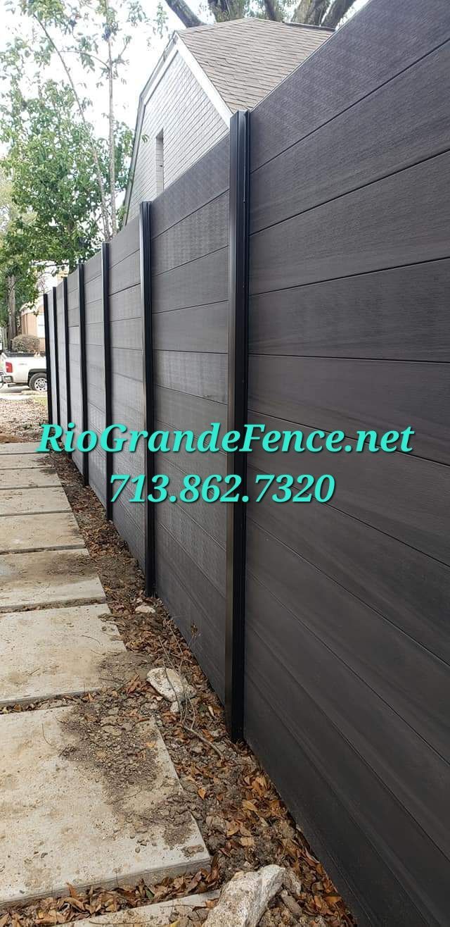A Black Wooden Fence Is Sitting Next to A Sidewalk - Houston, TX - Rio Grande Fence Company