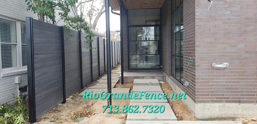 A Brick House with A Fence and A Walkway Leading to It - Houston, TX - Rio Grande Fence Company
