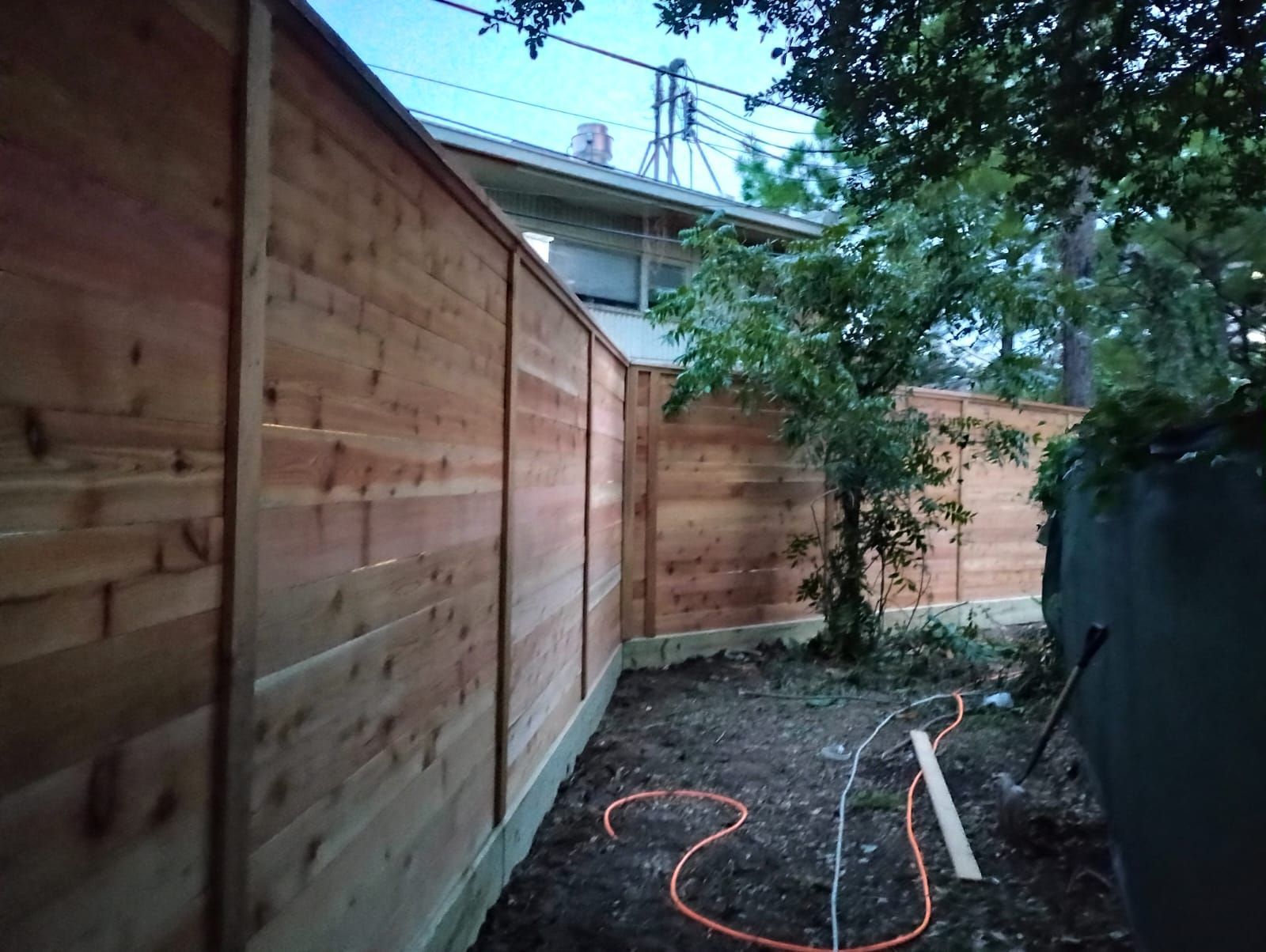 A Wooden Fence in A Backyard with A House in The Background - Houston, TX - Rio Grande Fence Company