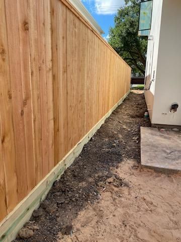 A Wooden Fence Is Being Built in The Backyard of A House - Houston, TX - Rio Grande Fence Company