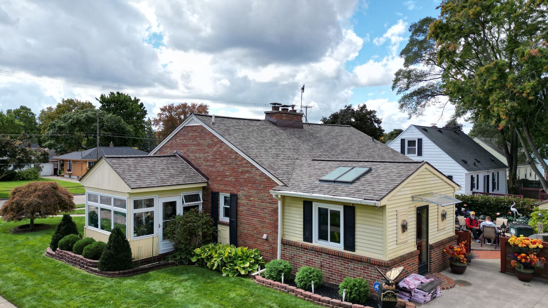 side photo of a house taken at low altitude by a drone that features skylights and a roof done by top shelf construction and consulting