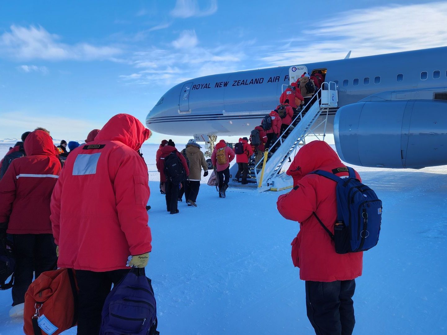 A group of people are boarding a canadian airplane