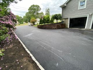 A residential asphalt driveway in Canton, MA by Norfolk Asphalt Paving & Excavation