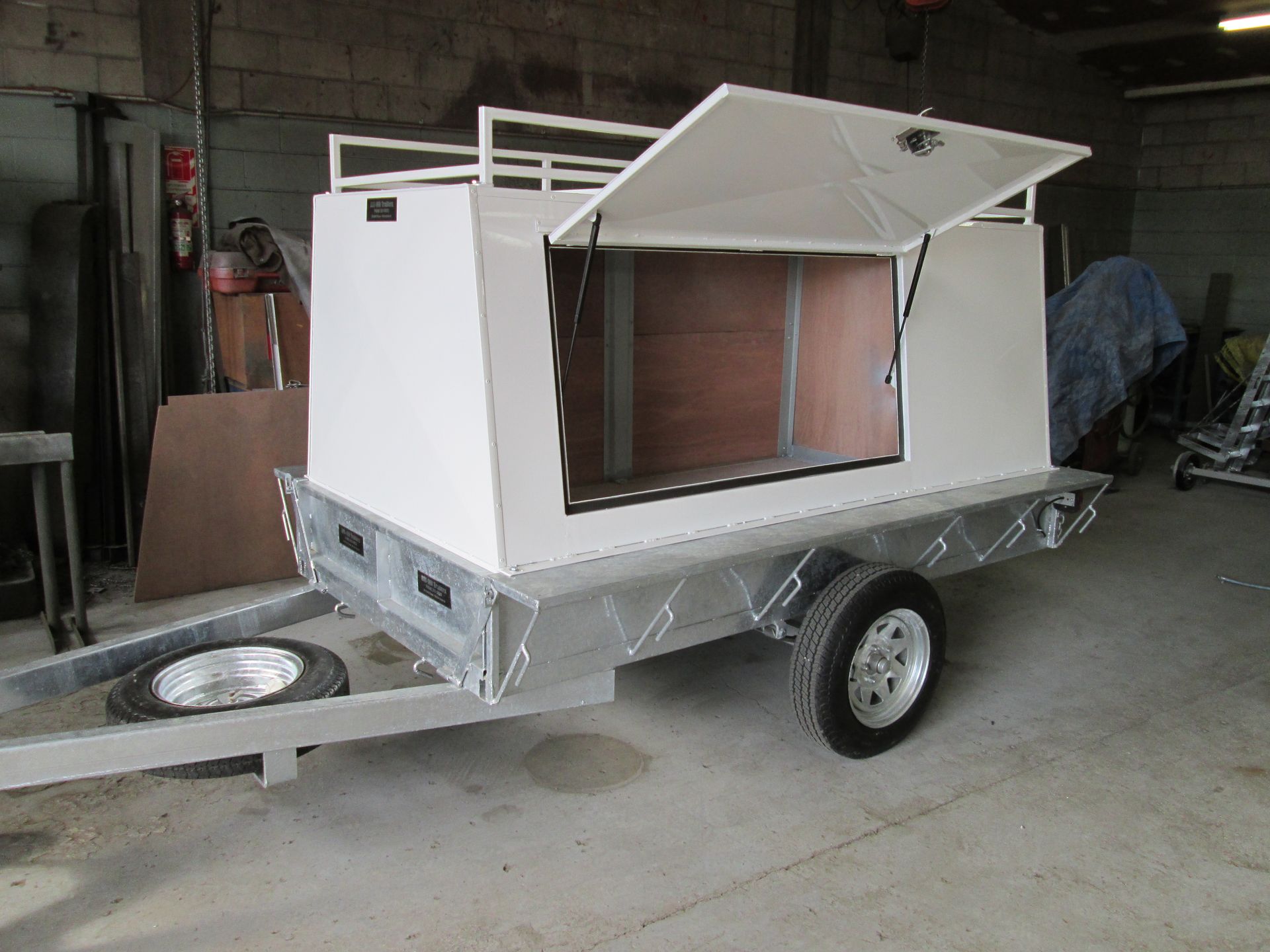 A pickup truck towing a white and black motorboat on a trailer on a road.