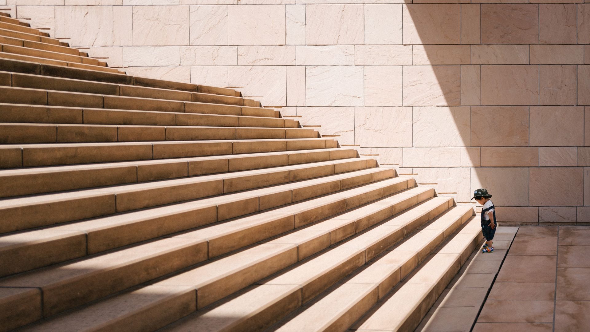 Child on irst step up a flight of stone stairs