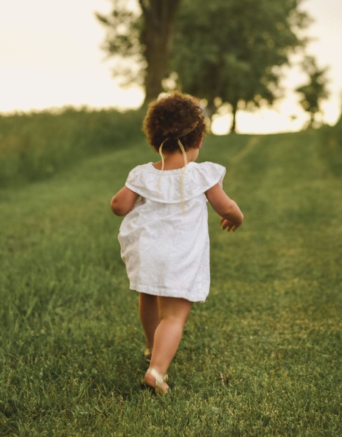 little girl progressively walking toward horizon