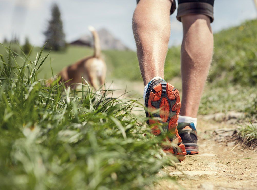 ManIn Sneakers Running With Dog — Quality Shoe Shop in Maroochydore, QLD