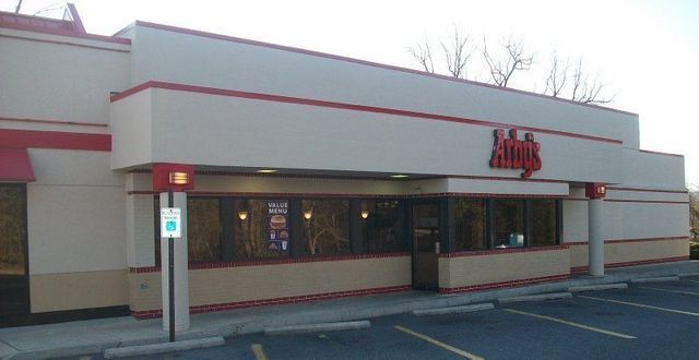 A Restaurant with A Parking Lot in Front of It