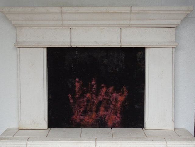A Fireplace with A Painting of A Hand on It