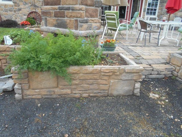 A Stone Wall with A Planter in The Middle of It