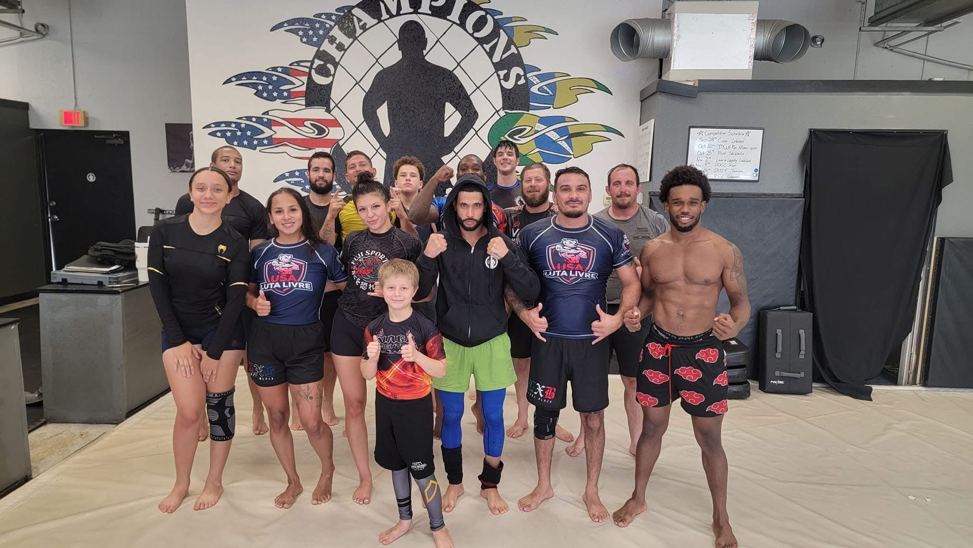 a man is laying on top of another man on a mat