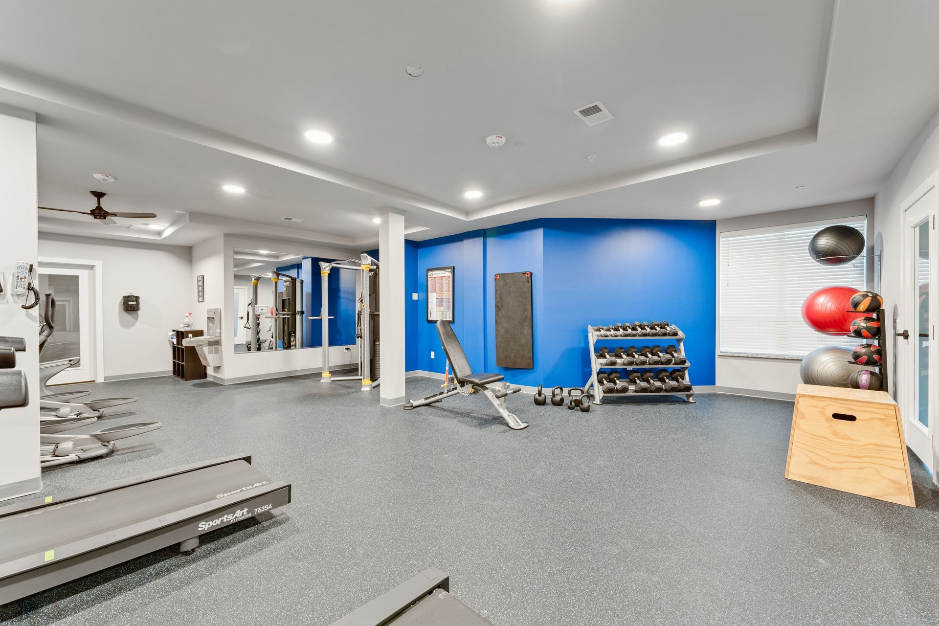 a gym with a treadmill that says stryker on it