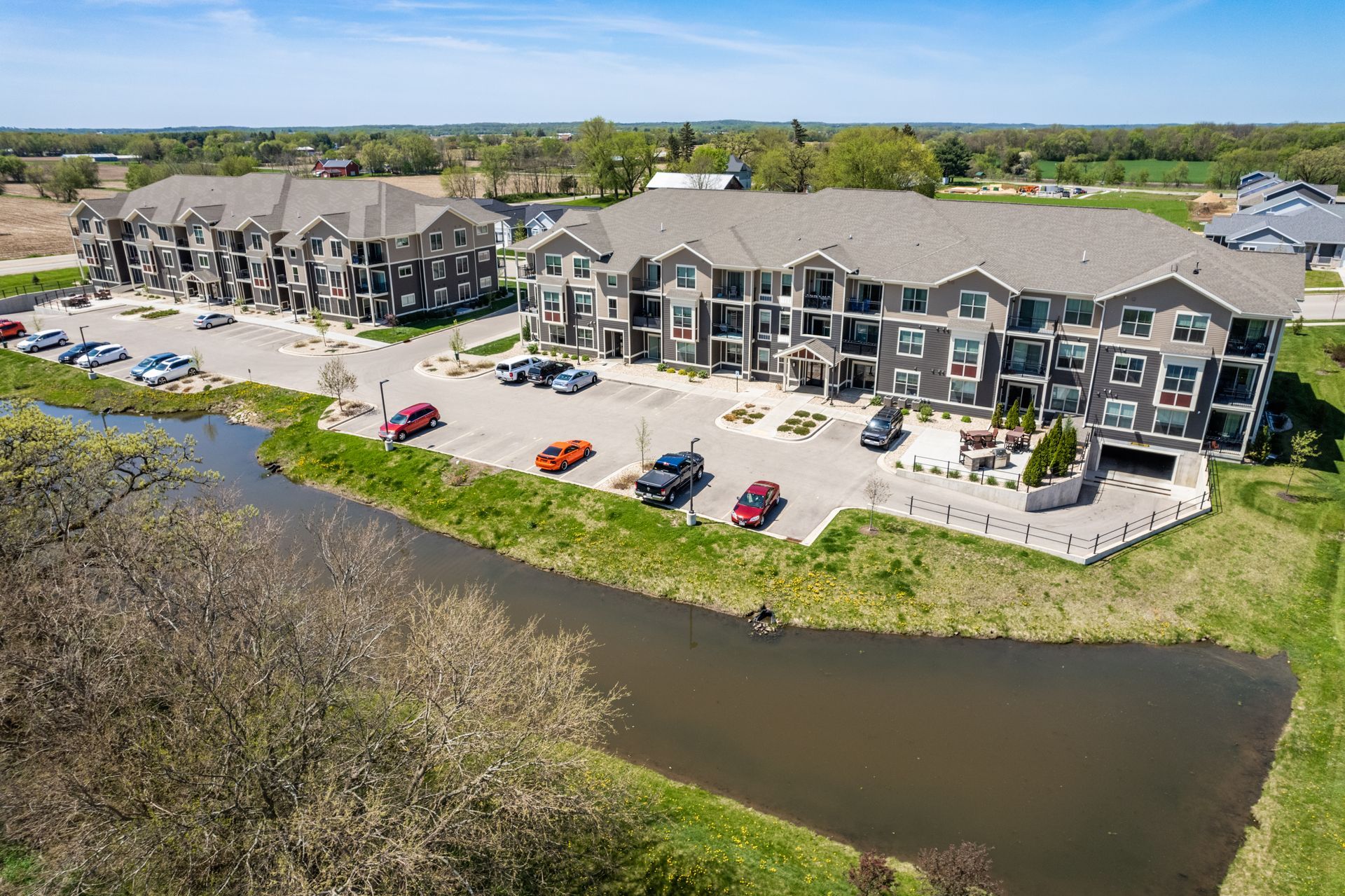 a large apartment building with cars parked in front of it