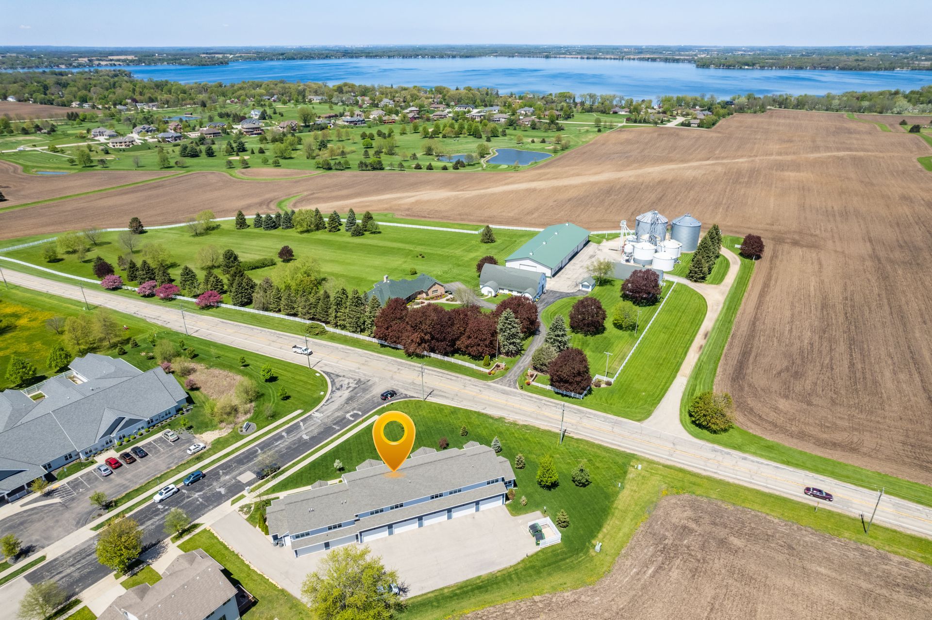 an aerial view of a house with a yellow pin pointing to it