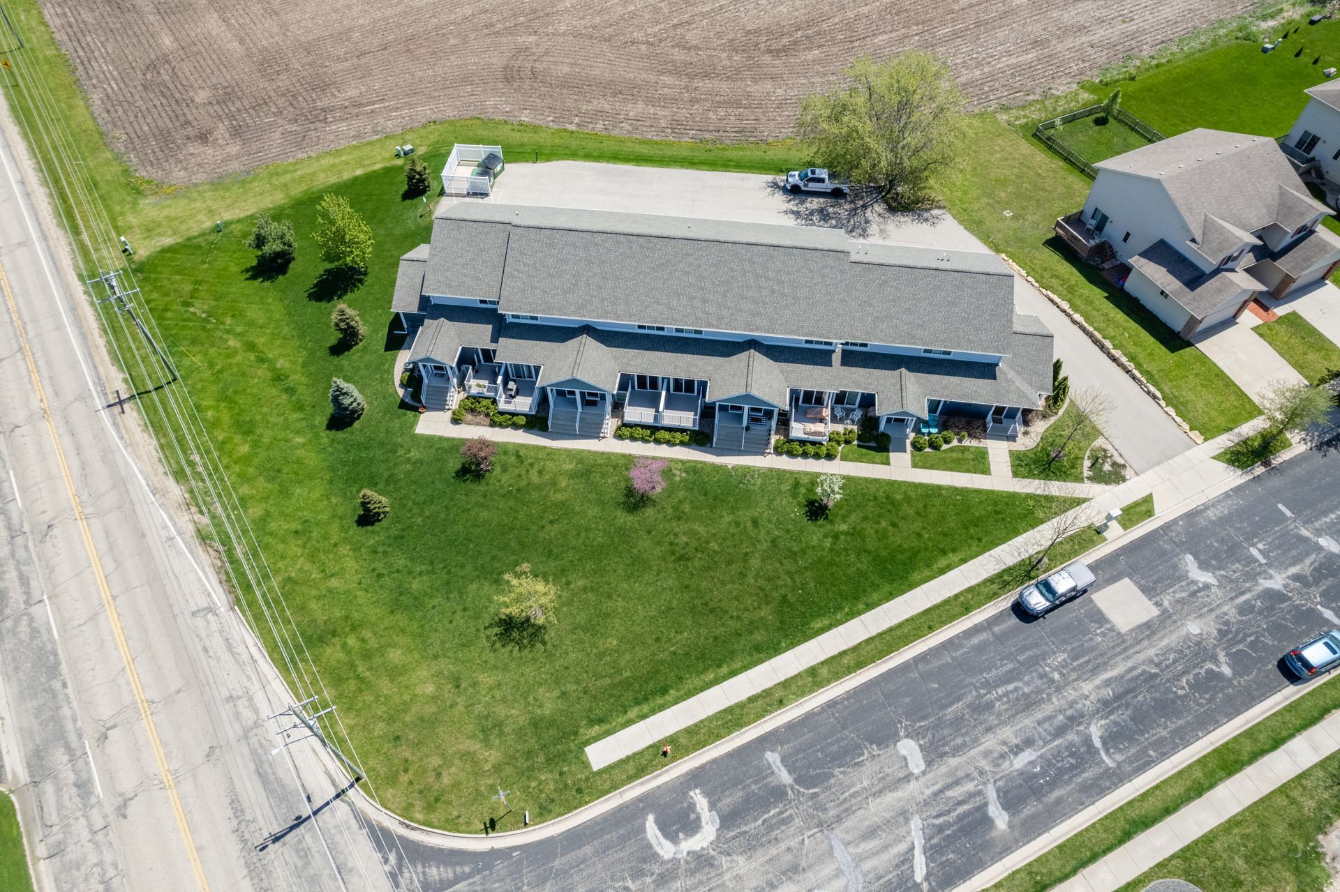 an aerial view of a residential area with houses and a parking lot