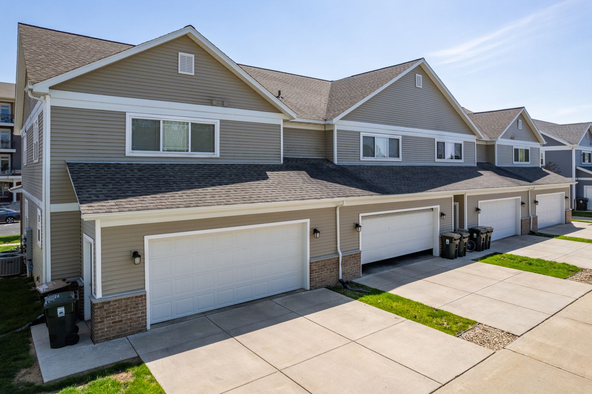a row of houses with a white garage door