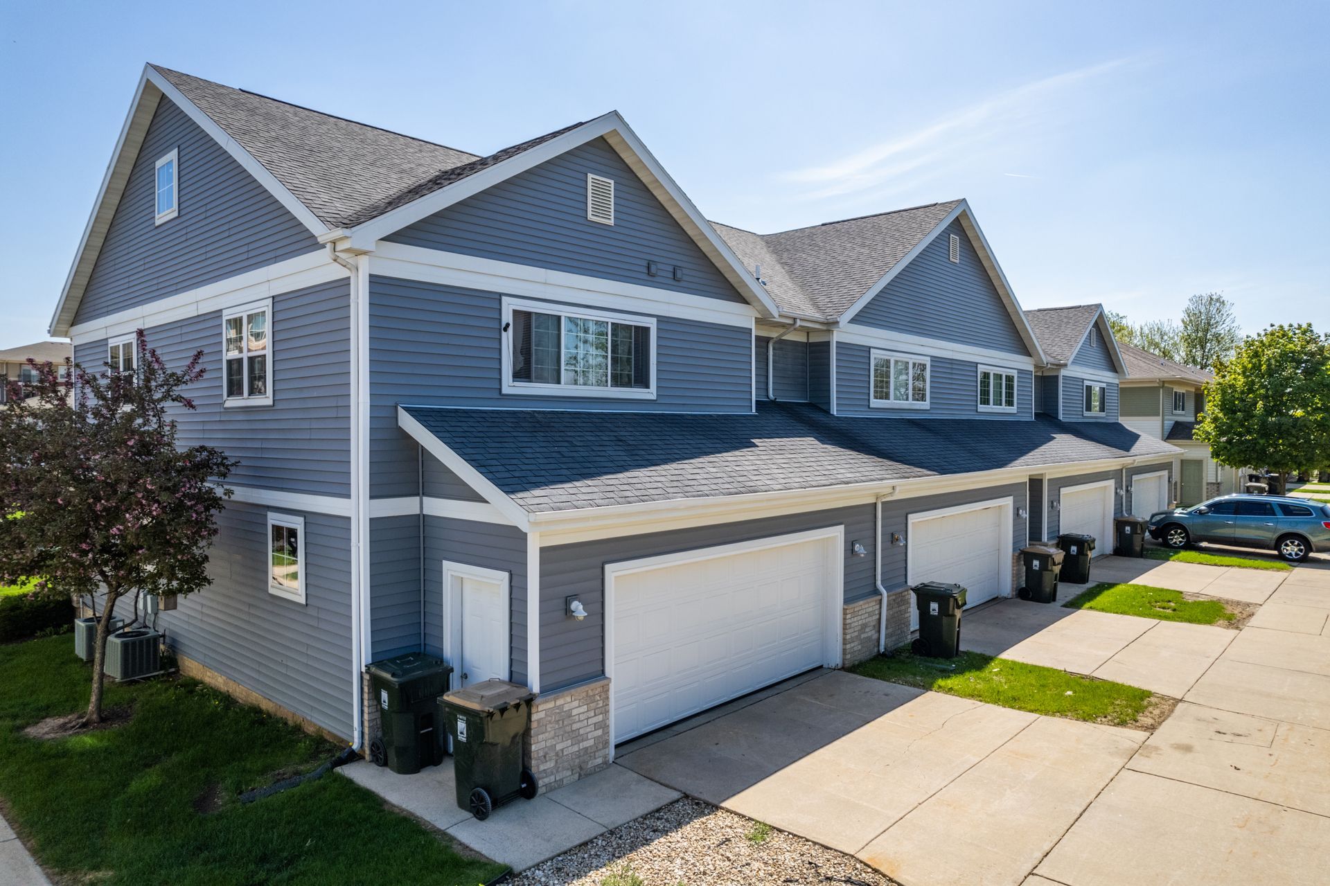 a row of houses with gray siding and white trim