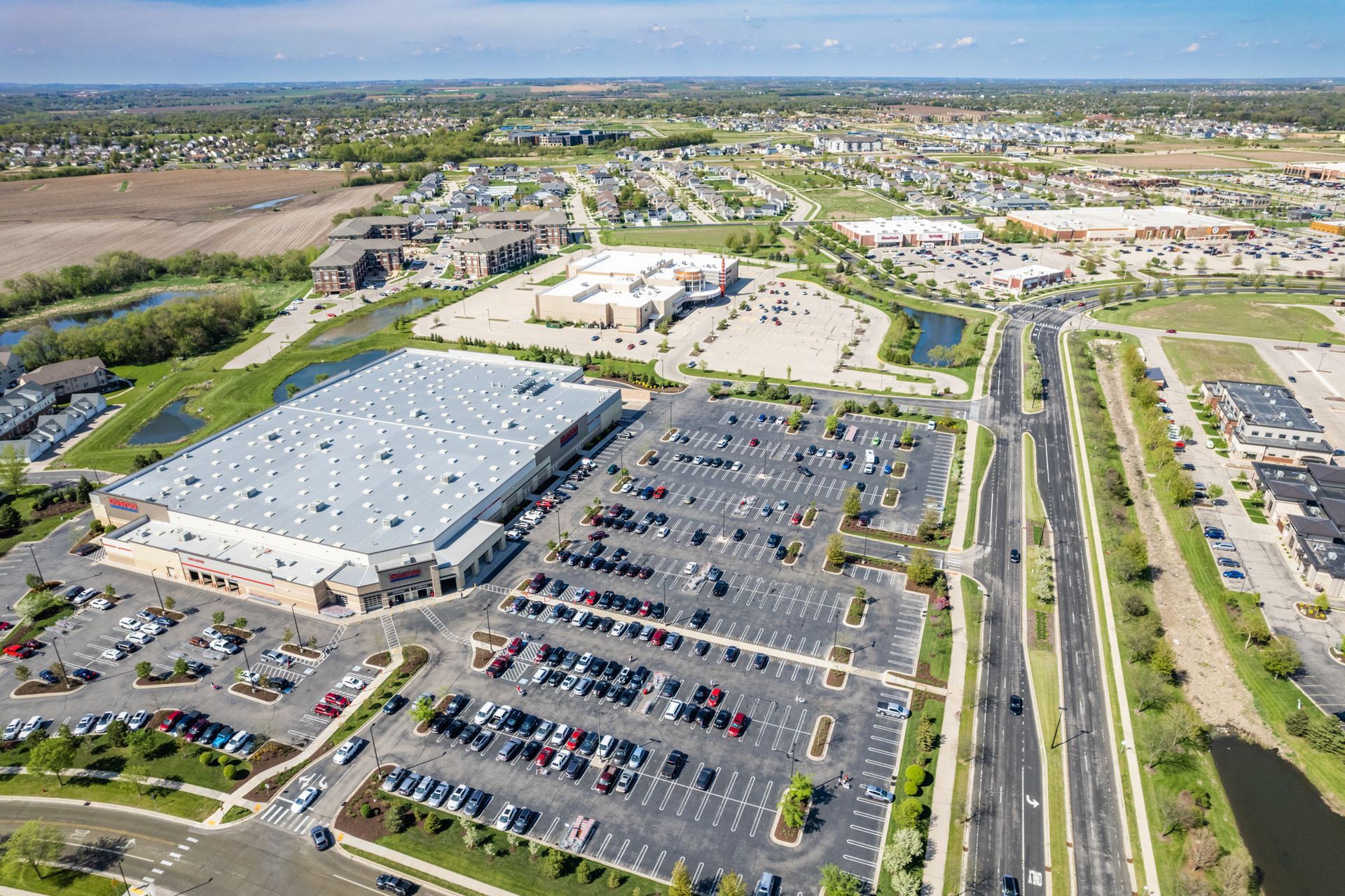 an aerial view of a shopping center with lots of parking