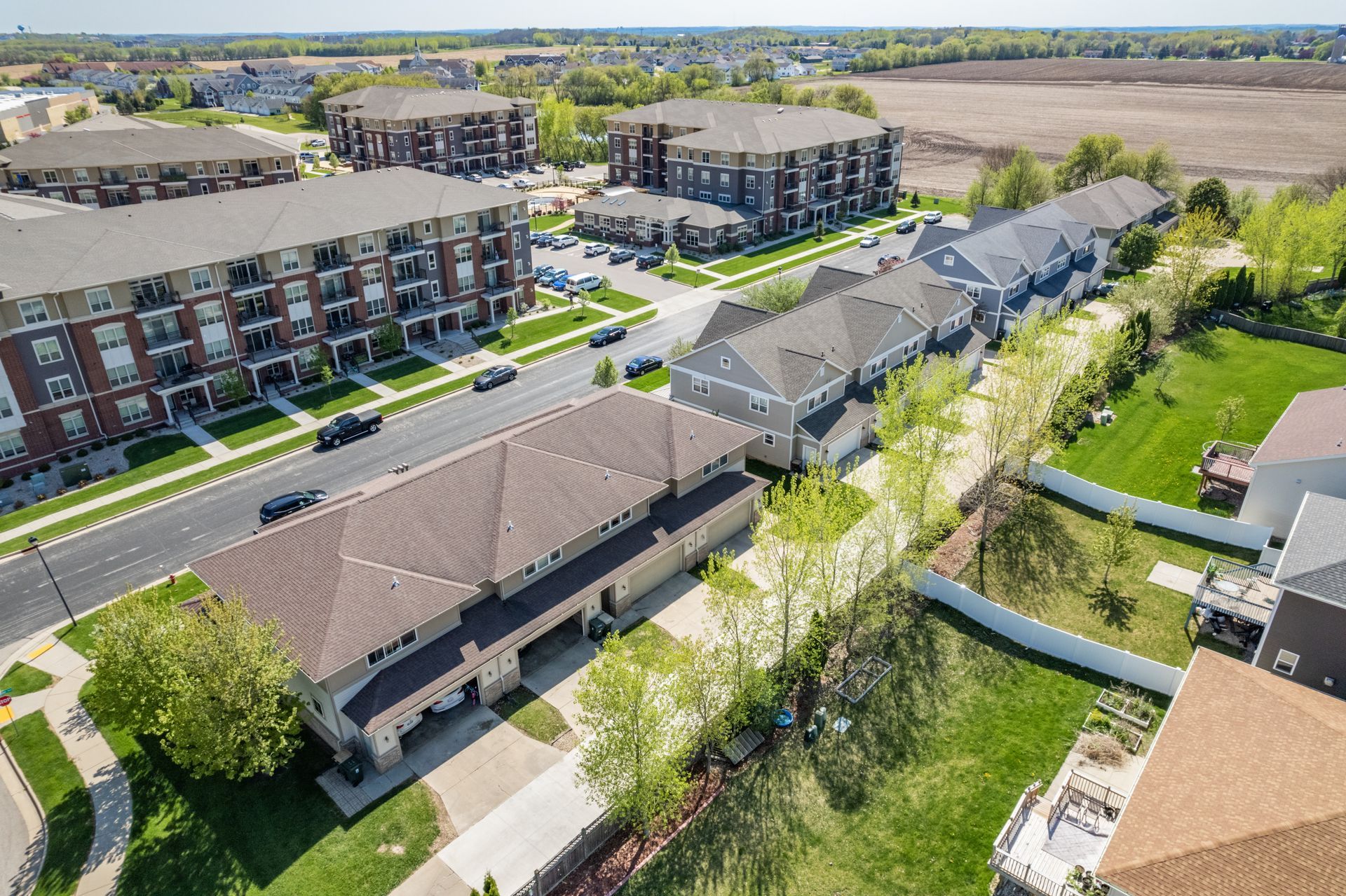 an aerial view of a residential neighborhood with a large apartment building in the background