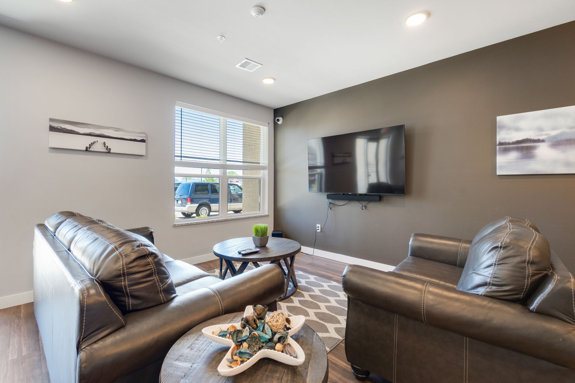 a living room with two couches and a flat screen tv