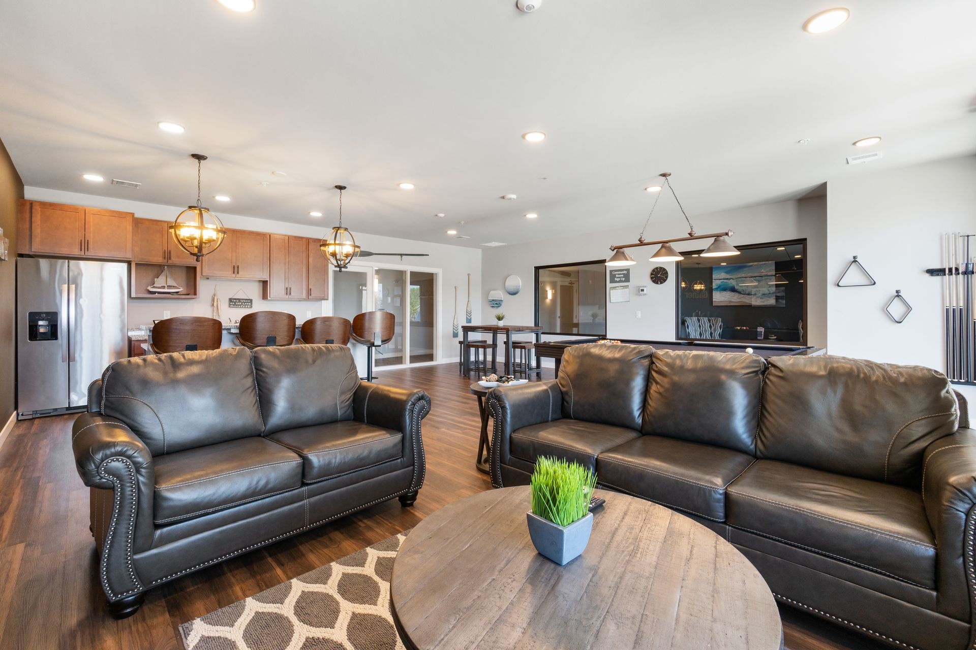 a living room with two leather couches and a coffee table