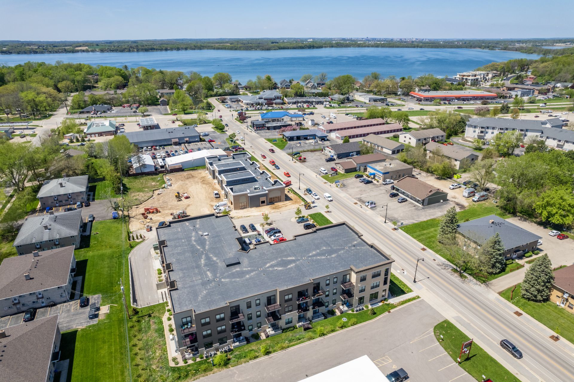 an aerial view of a city with a lake in the background