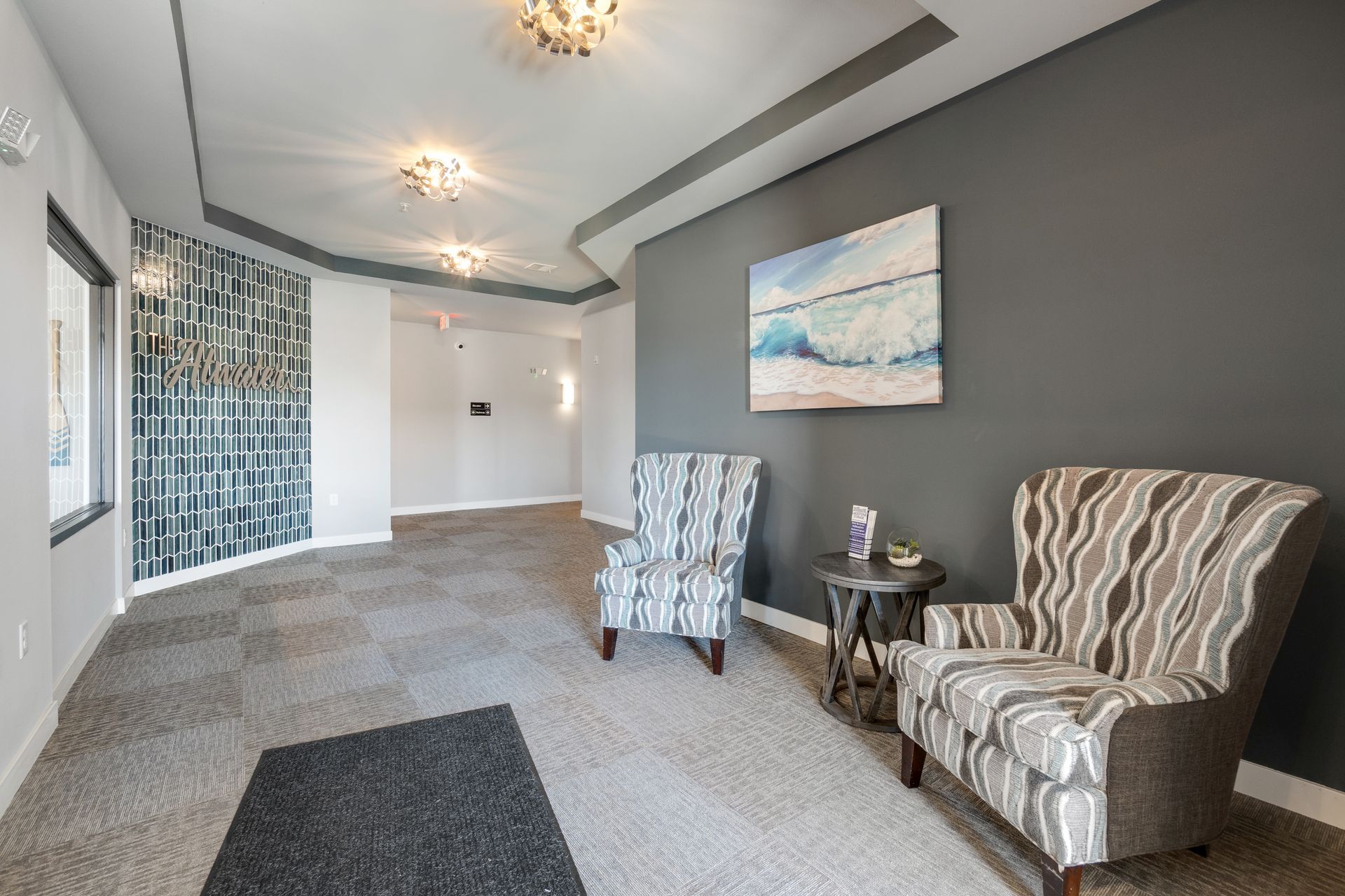 a hallway with two chairs and a painting on the wall that says always