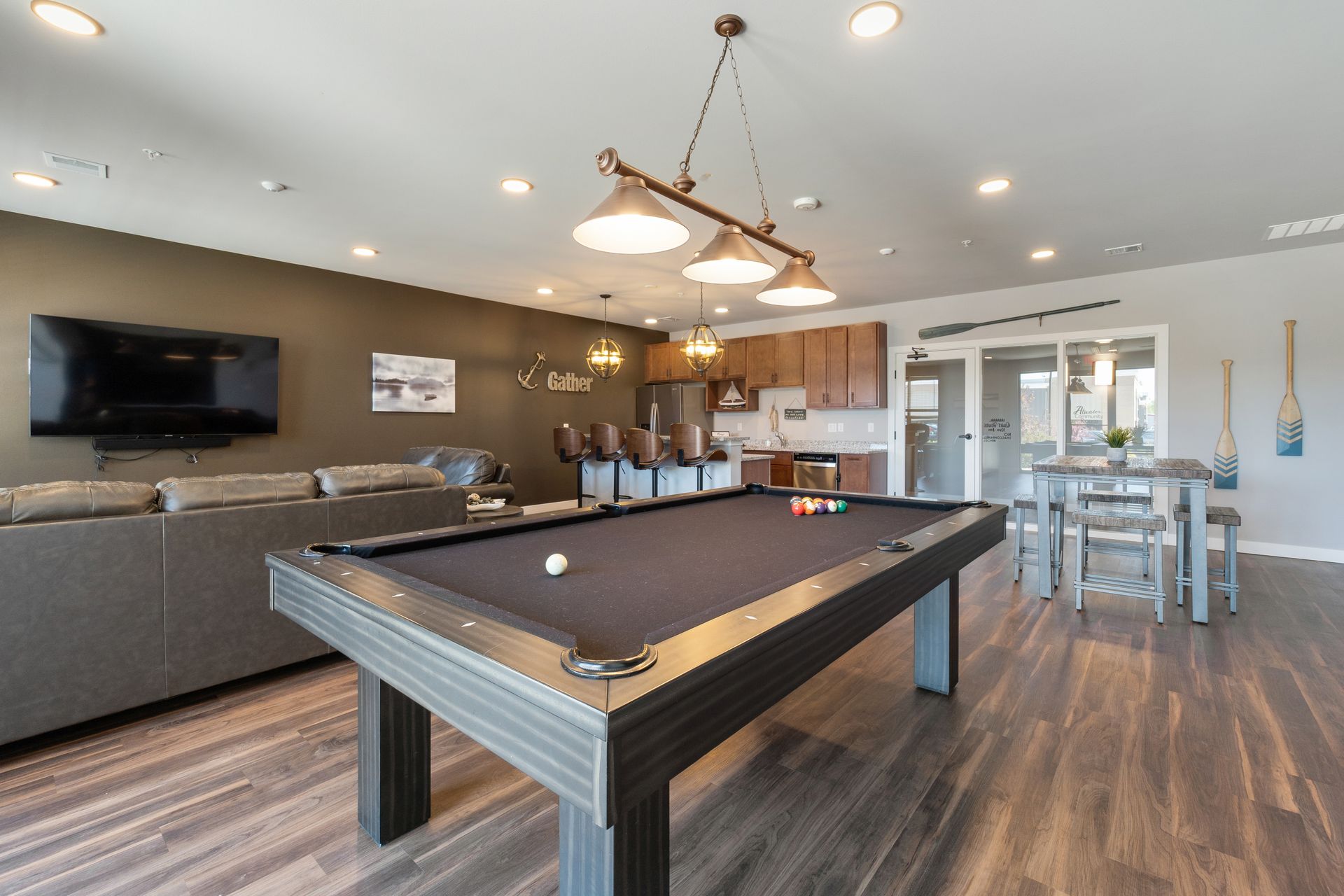 a pool table is in the middle of a living room