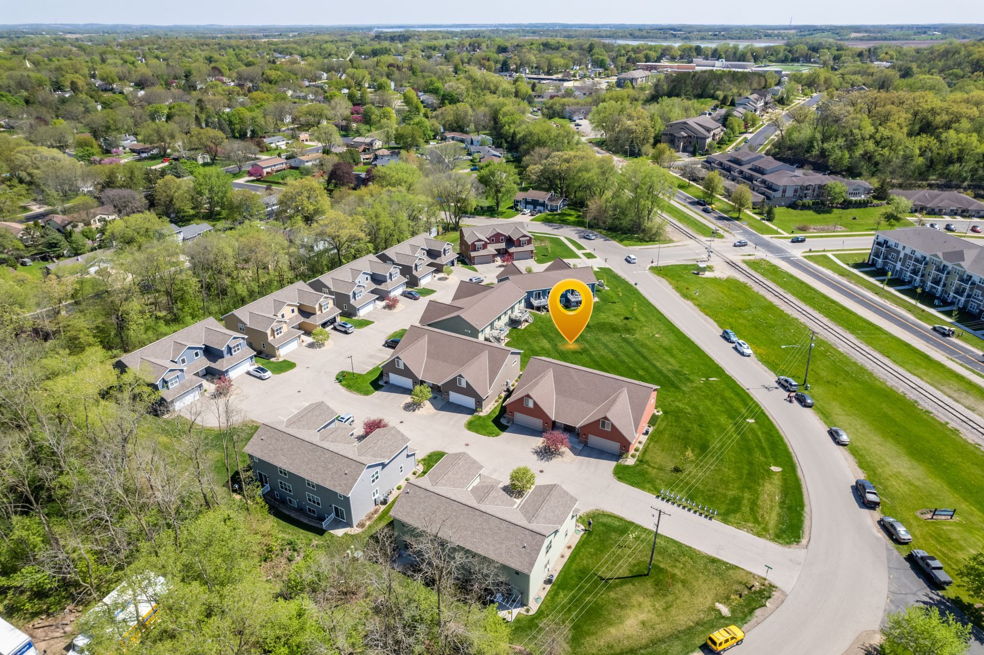 an aerial view of a residential area with a yellow pin pointing to a house