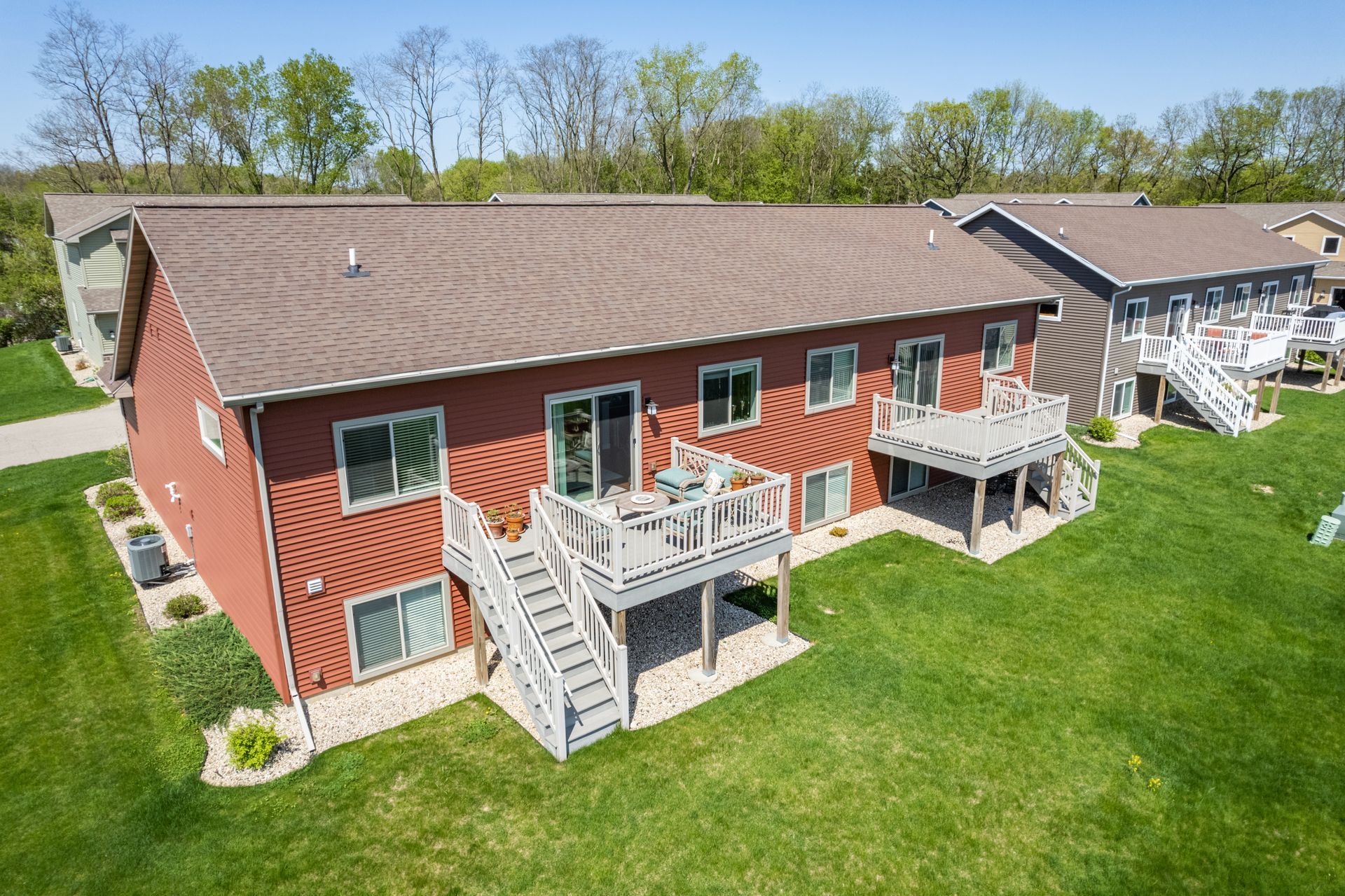 an aerial view of a house with two decks and stairs