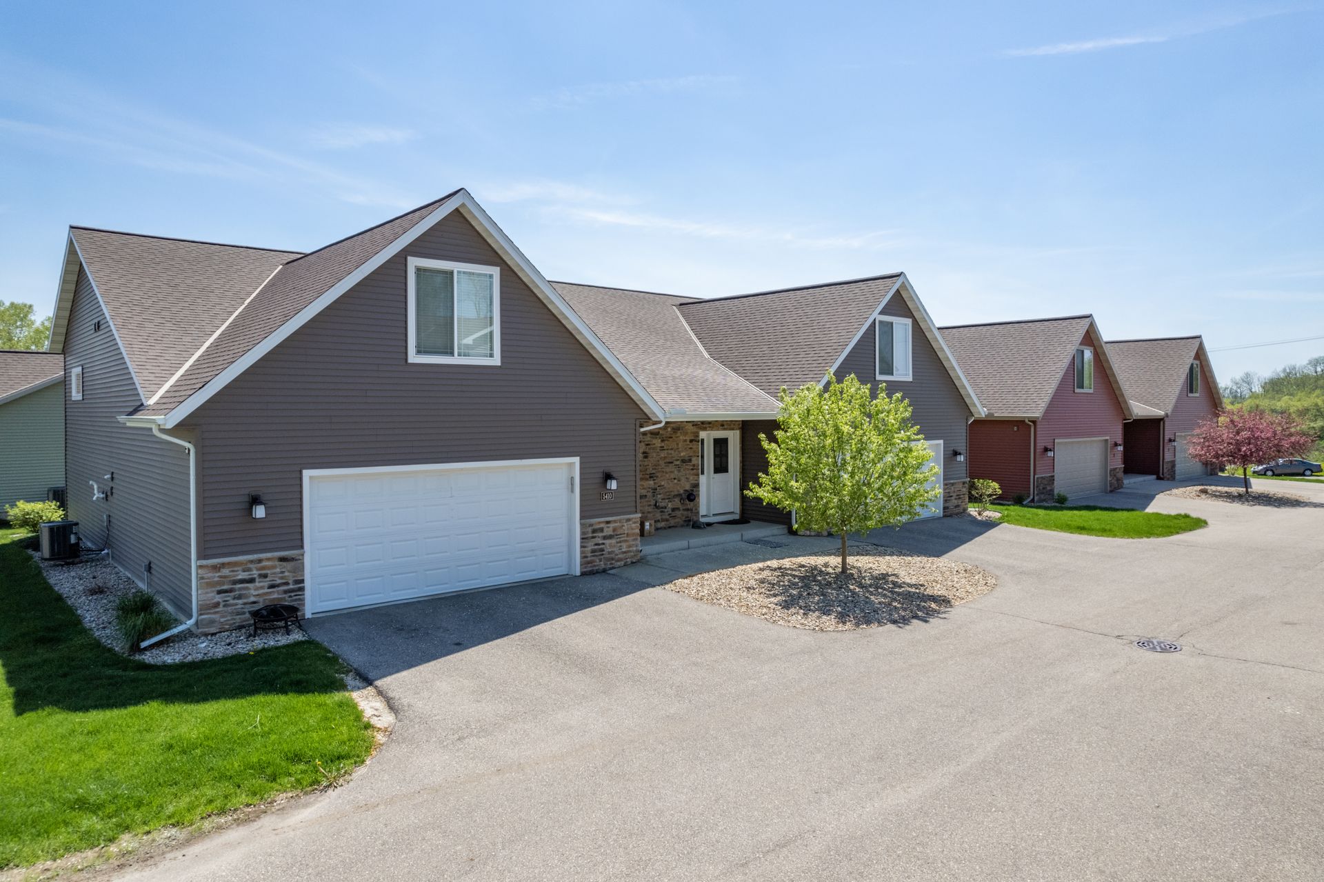 a row of houses with a white garage door