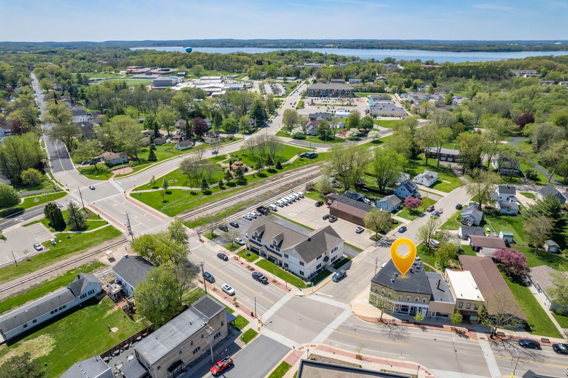 an aerial view of a small town with a yellow marker pointing to a building