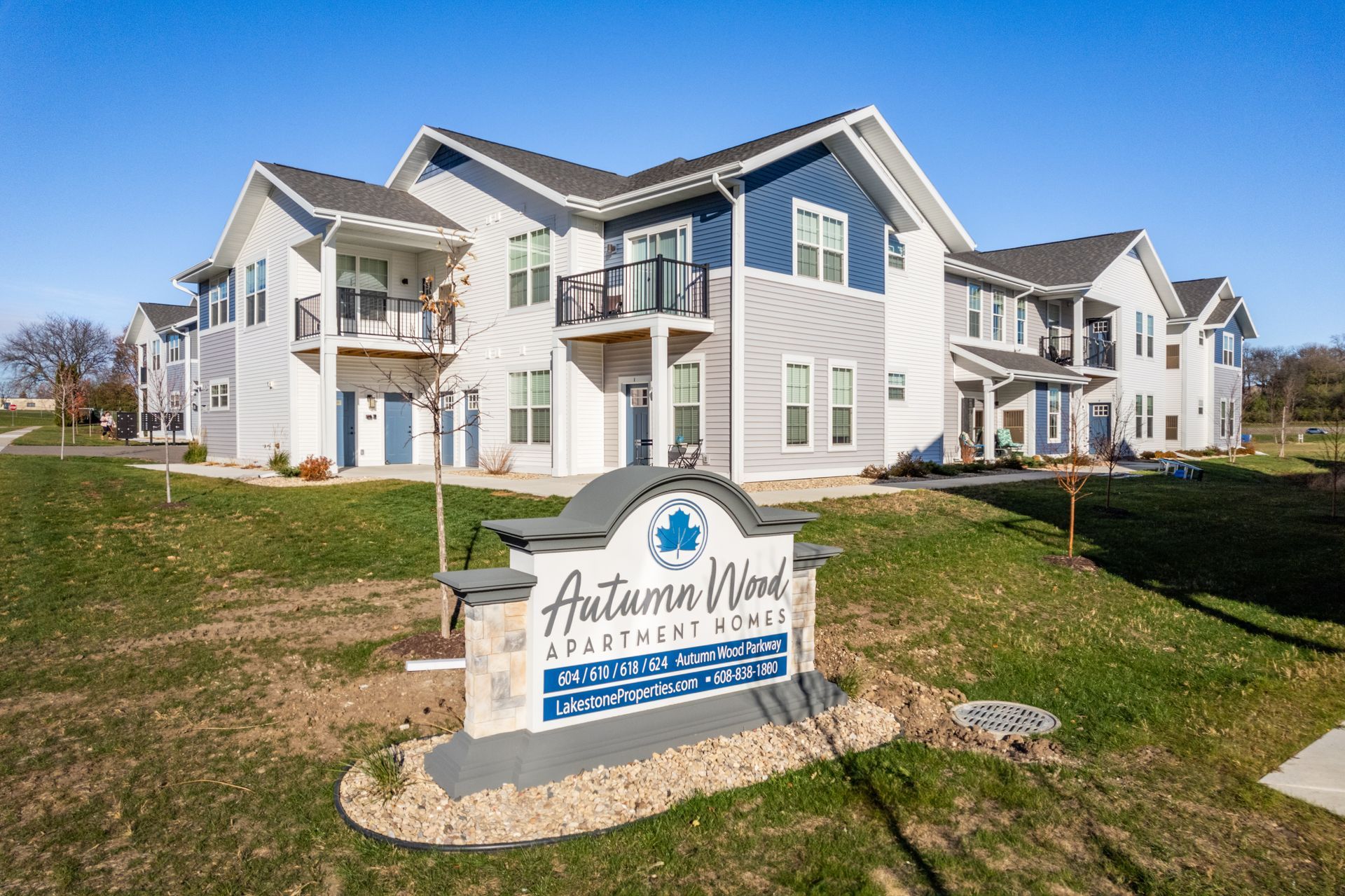 autumn wood apartment homes has a sign in front of it