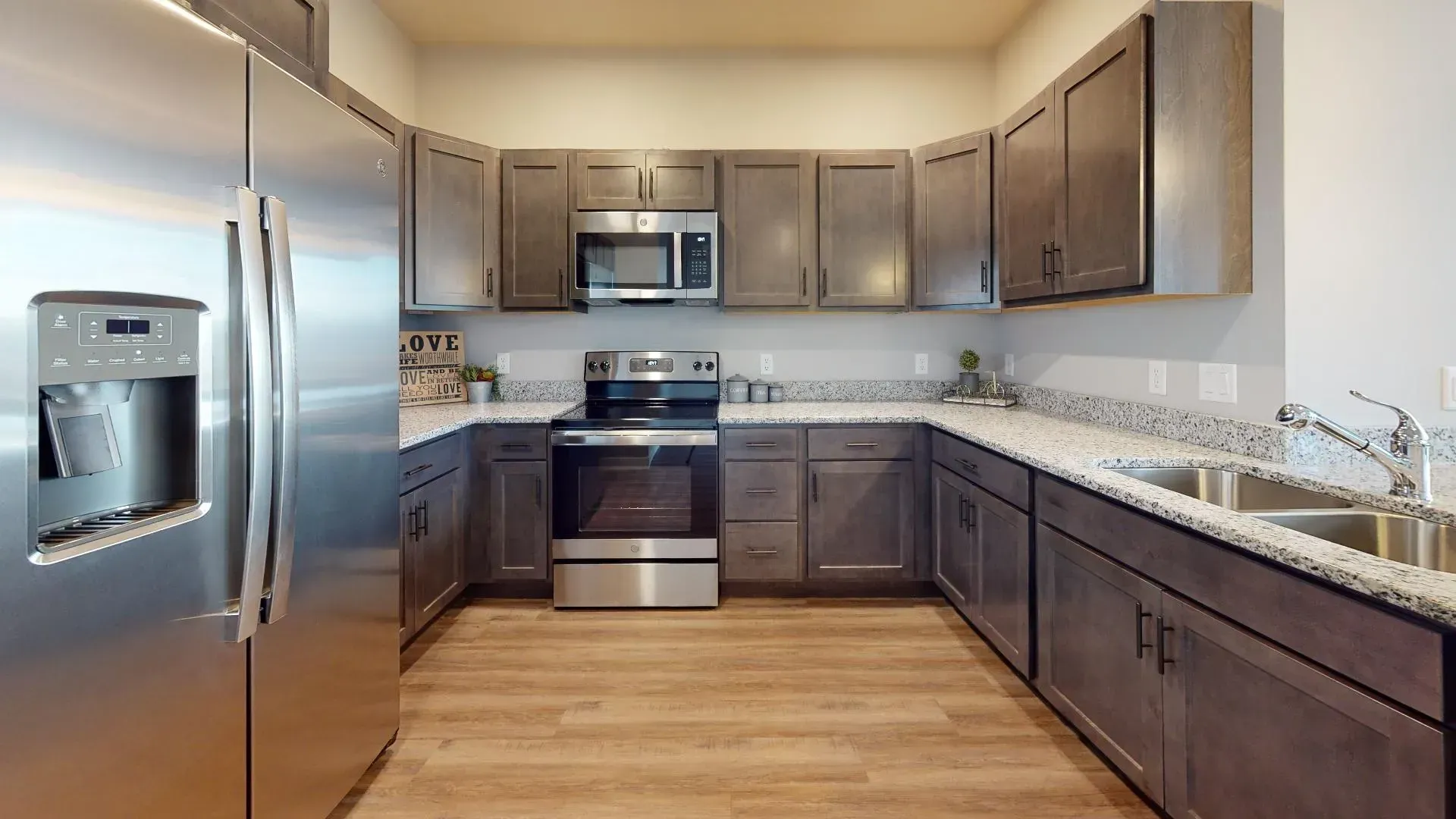 a kitchen with stainless steel appliances and granite counter tops