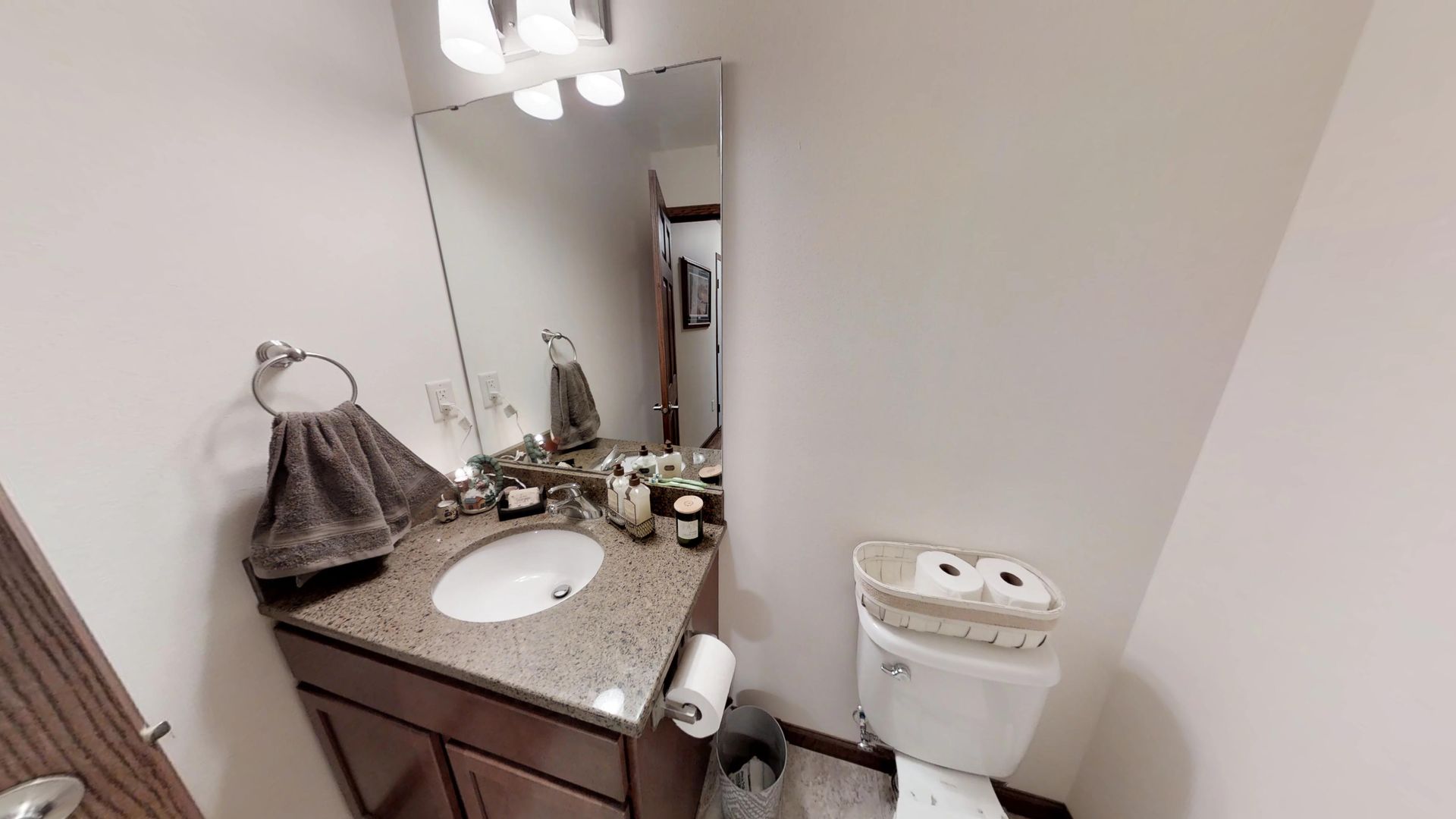 a bathroom with a sink toilet and mirror