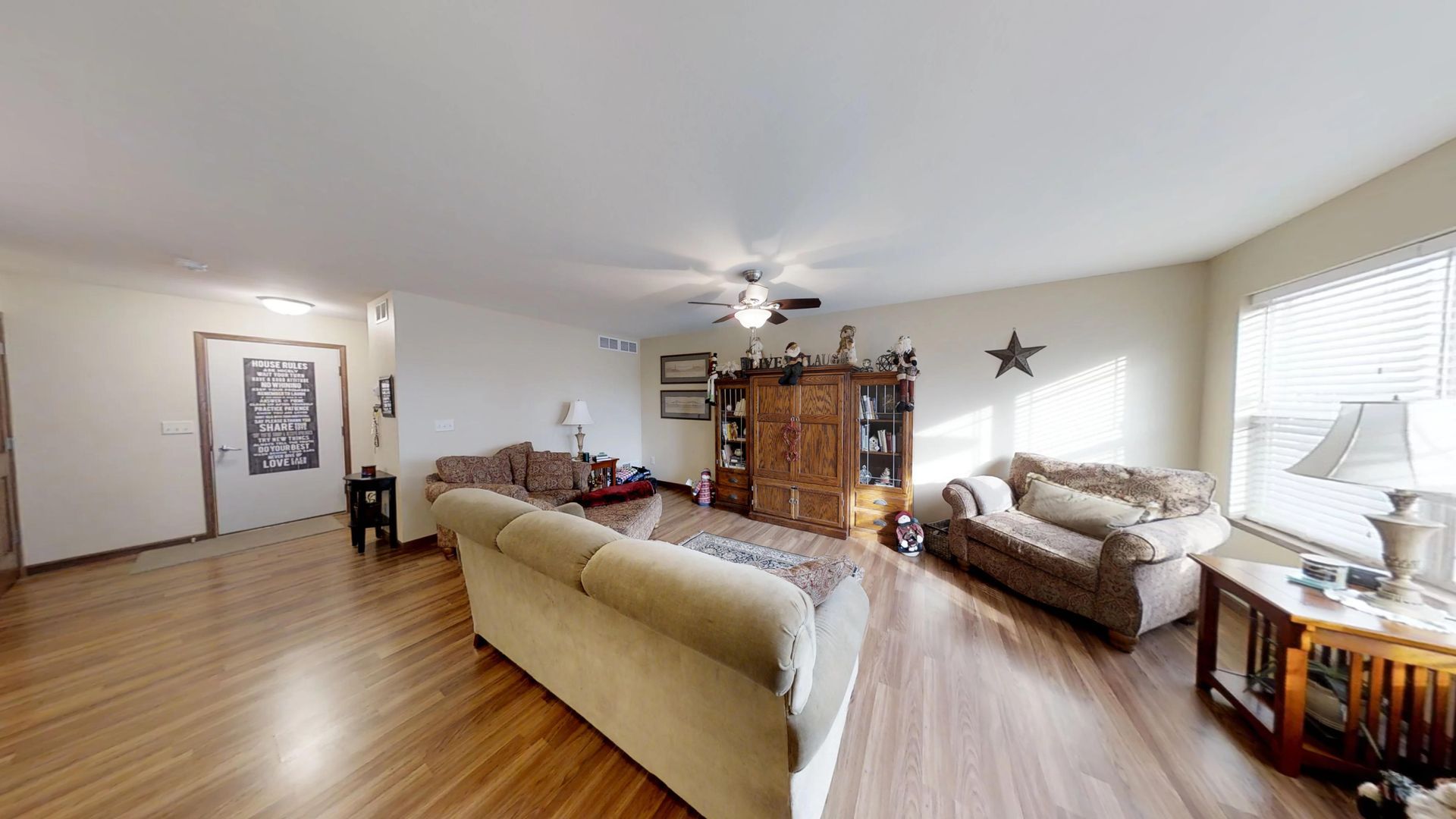 a living room with a sign on the wall that says