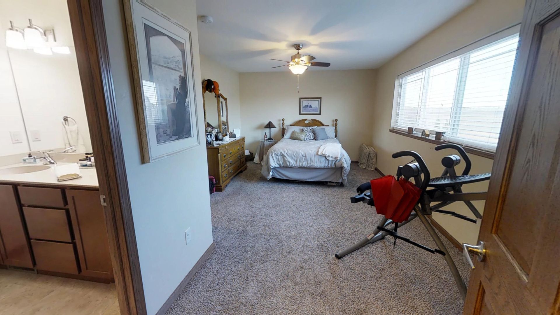 a bedroom with a bed and a ceiling fan