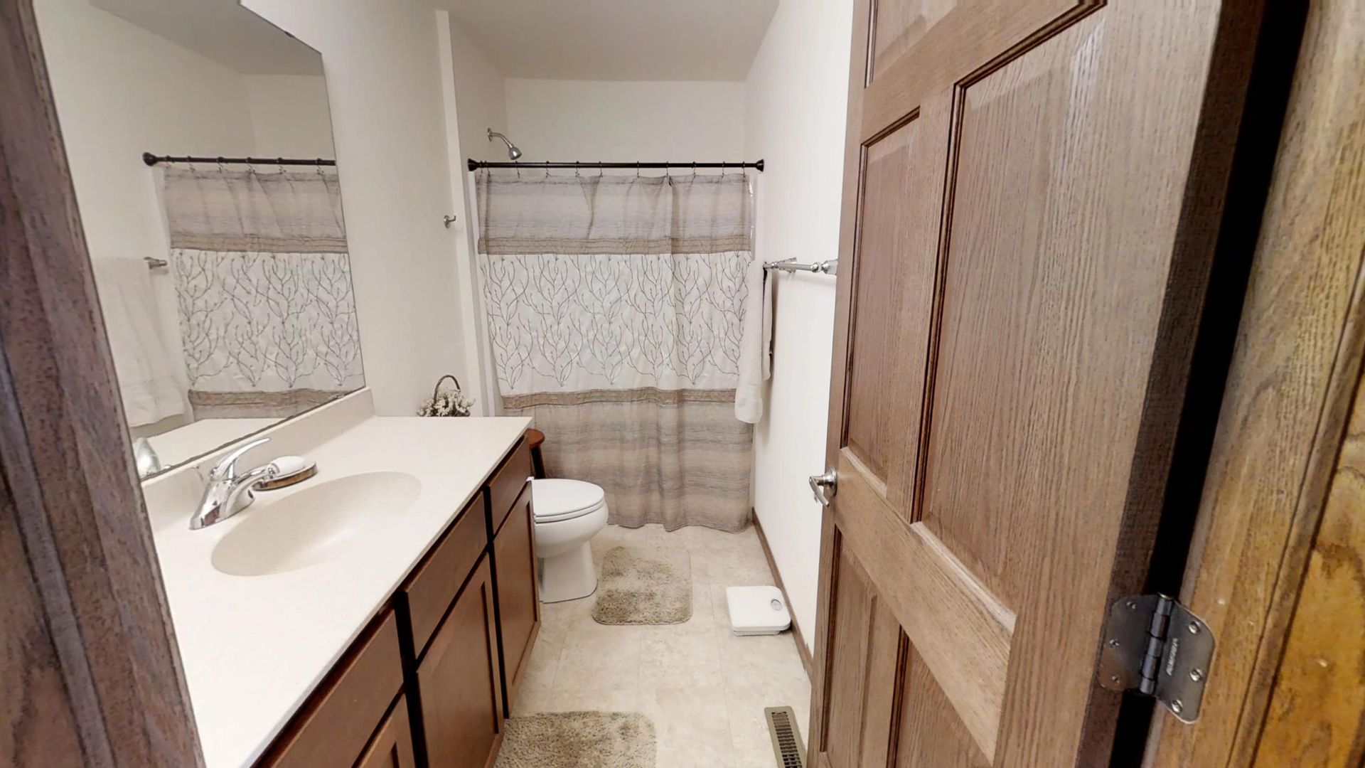 a bathroom with a toilet a sink and a mirror