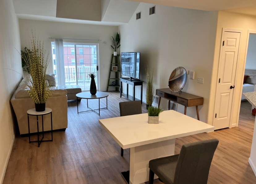a living room with a white table and chairs