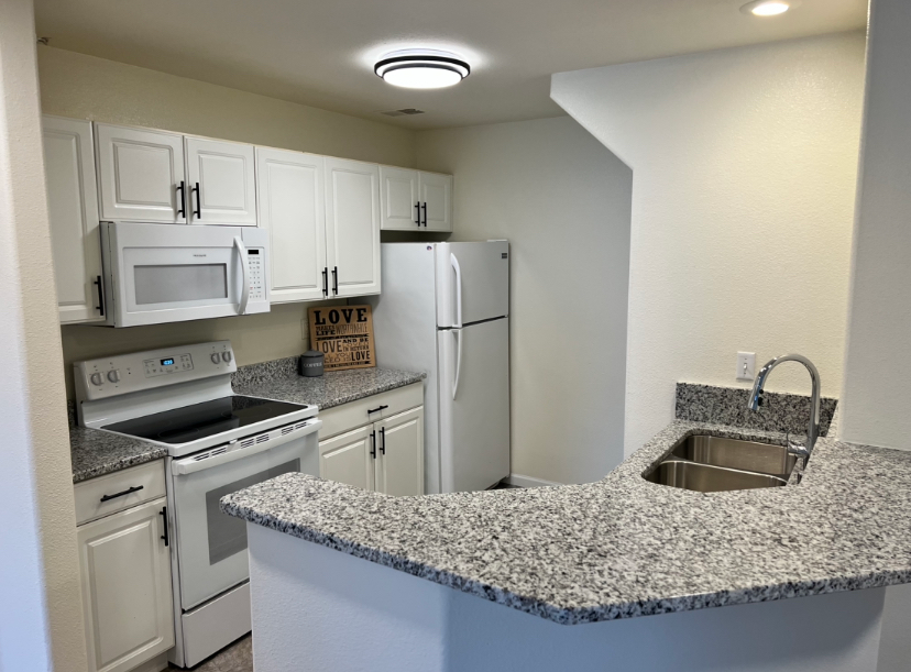 a kitchen with a sign that says love on it