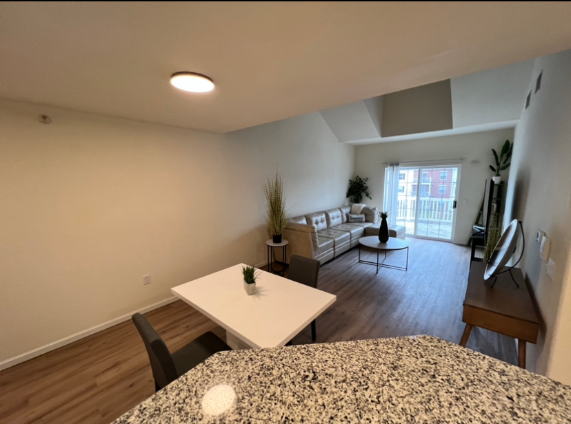 a living room with a table and chairs and a couch