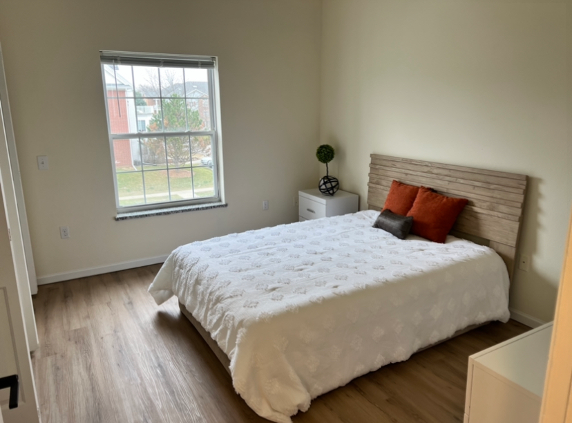 a bedroom with a large bed and a window