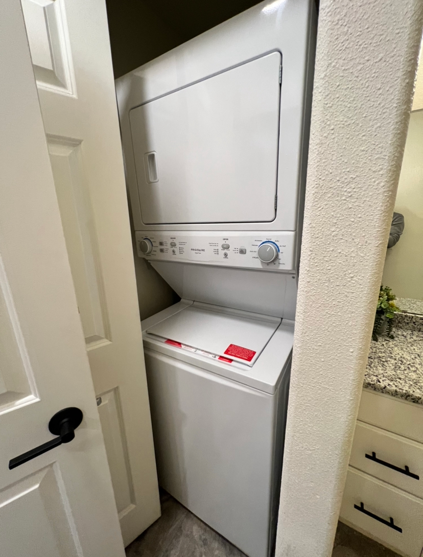 a frigidaire washer and dryer are stacked on top of each other