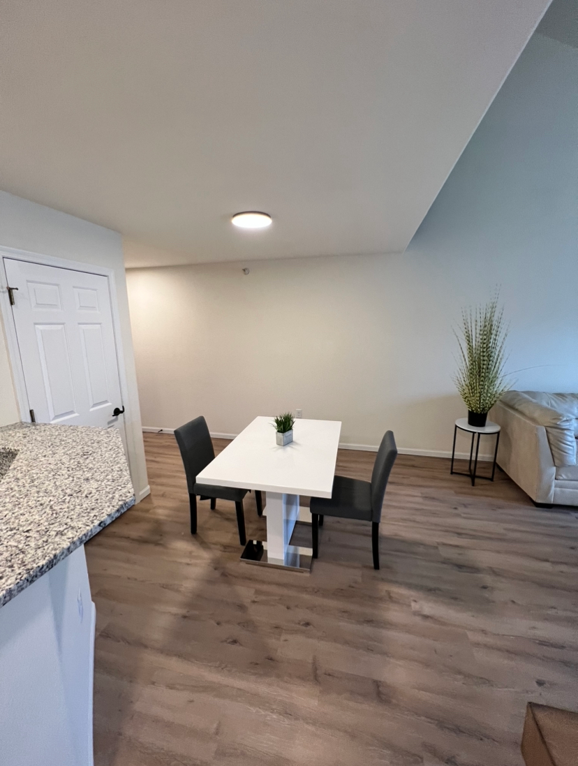 an empty room with a table and chairs in it