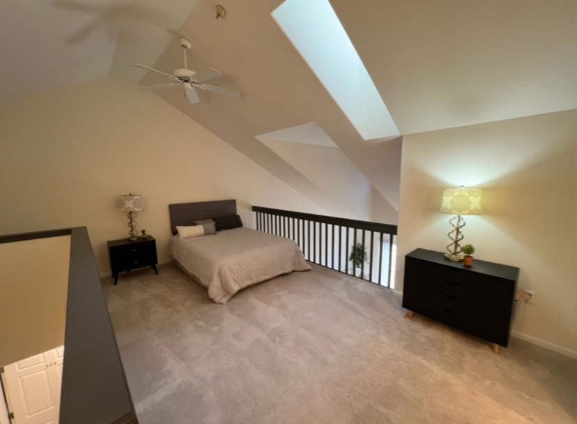 a bedroom with a bed and a ceiling fan