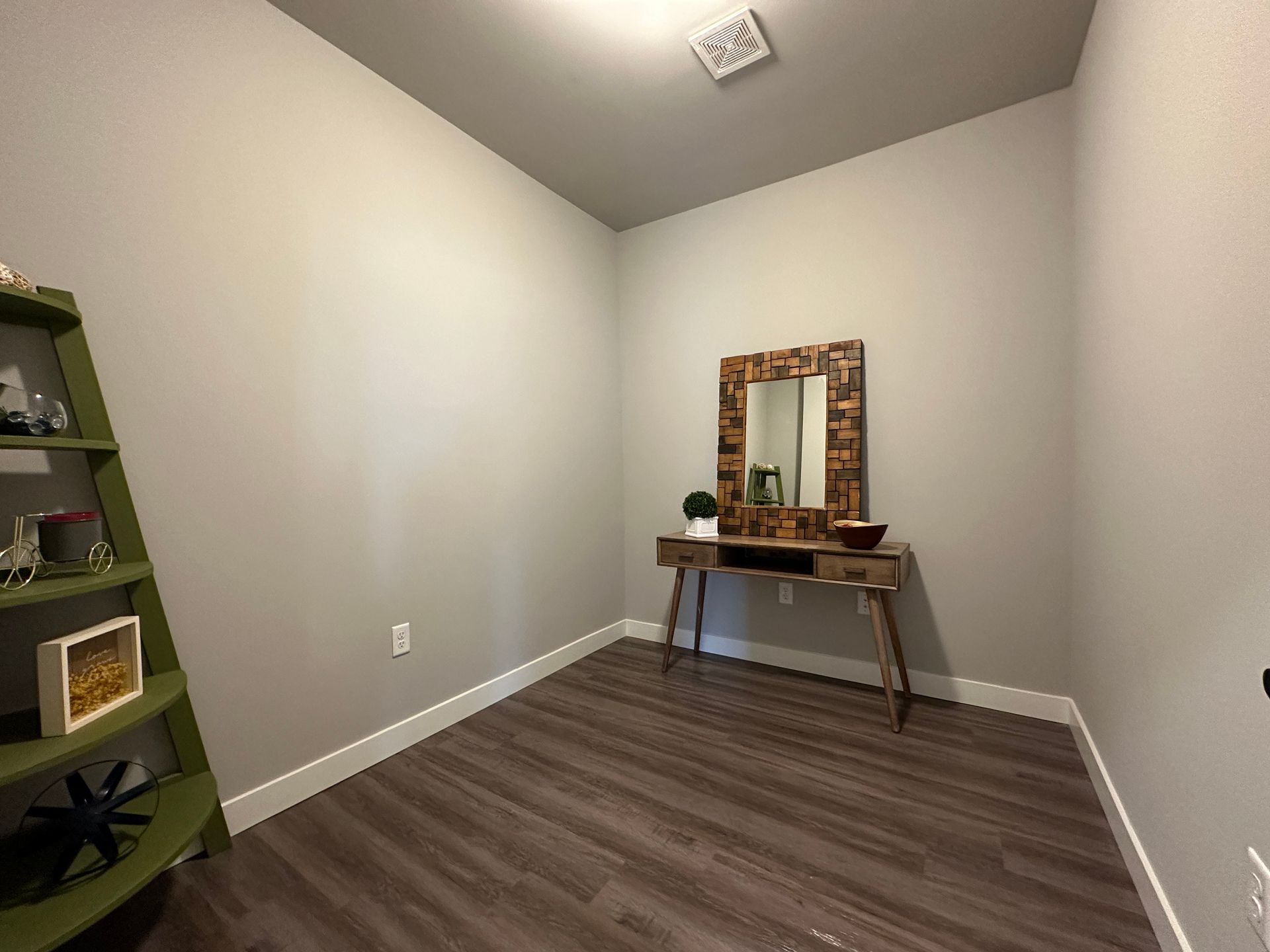 a small room with a wooden table and a mirror