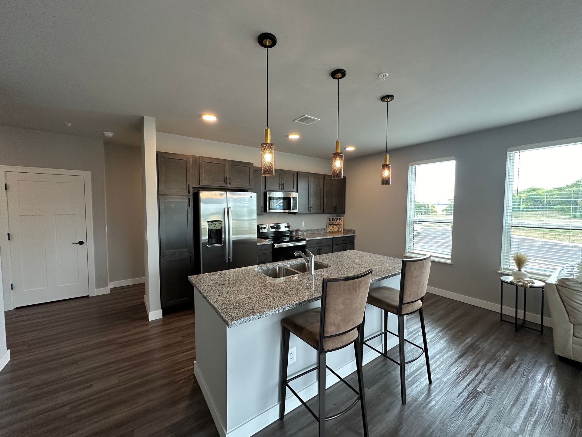 a kitchen with granite counter tops and stainless steel appliances