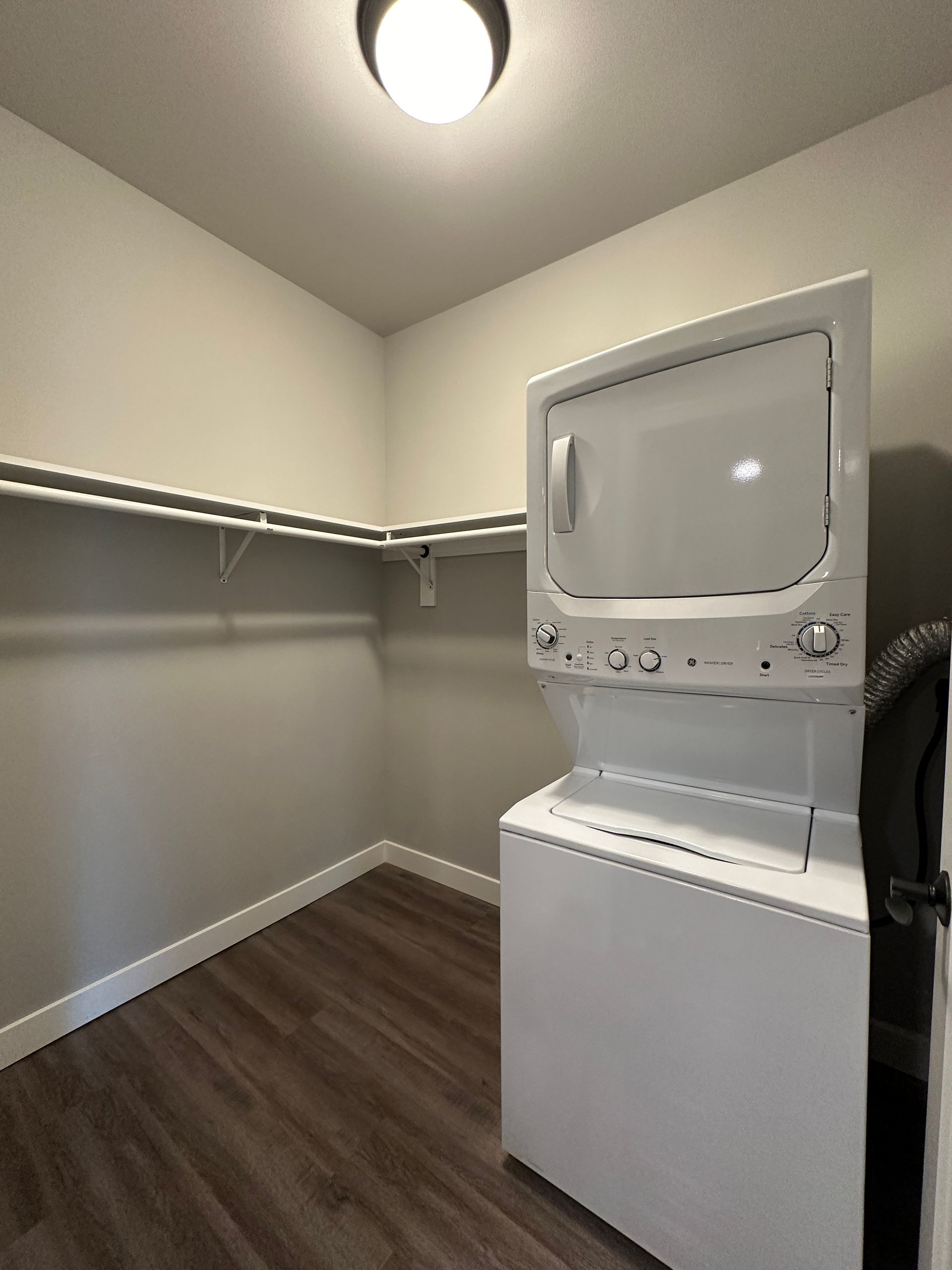 a washer and dryer stacked on top of each other in a closet